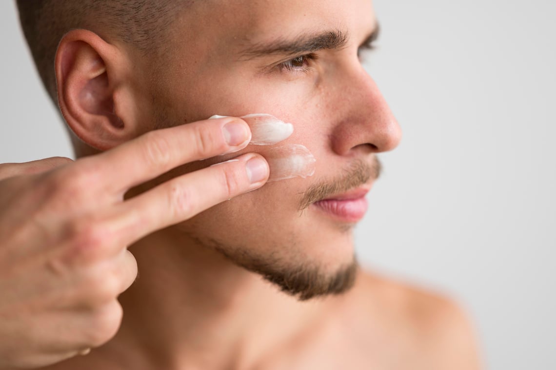 side-view-handsome-man-applying-cream-his-face